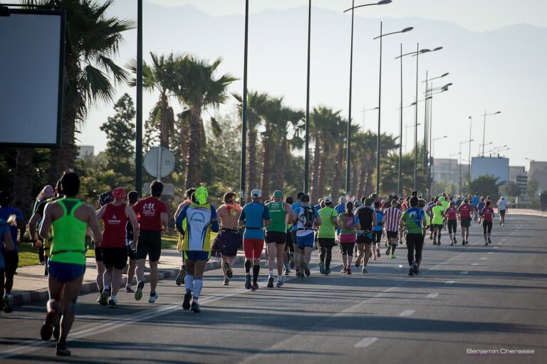 Runners passing along a road during the Marrakech Marathon 2025