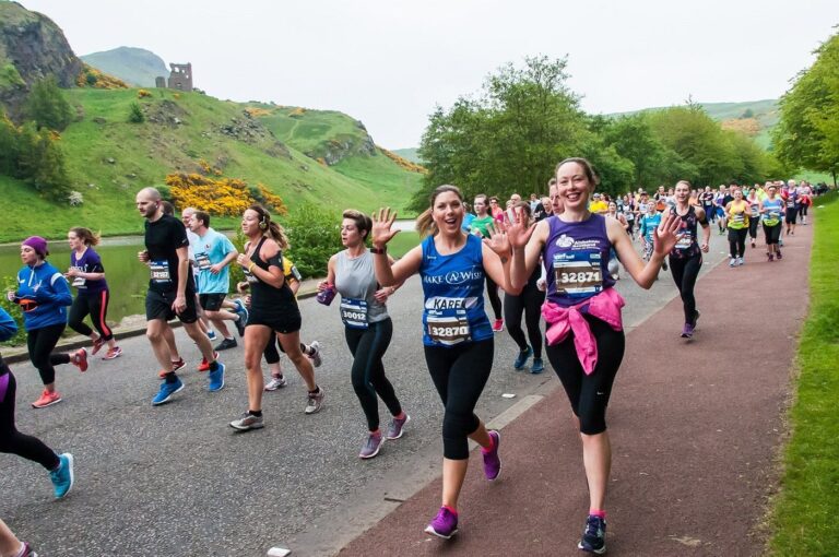 Photo of runners happily taking part in the Edinburgh Marathon 2024