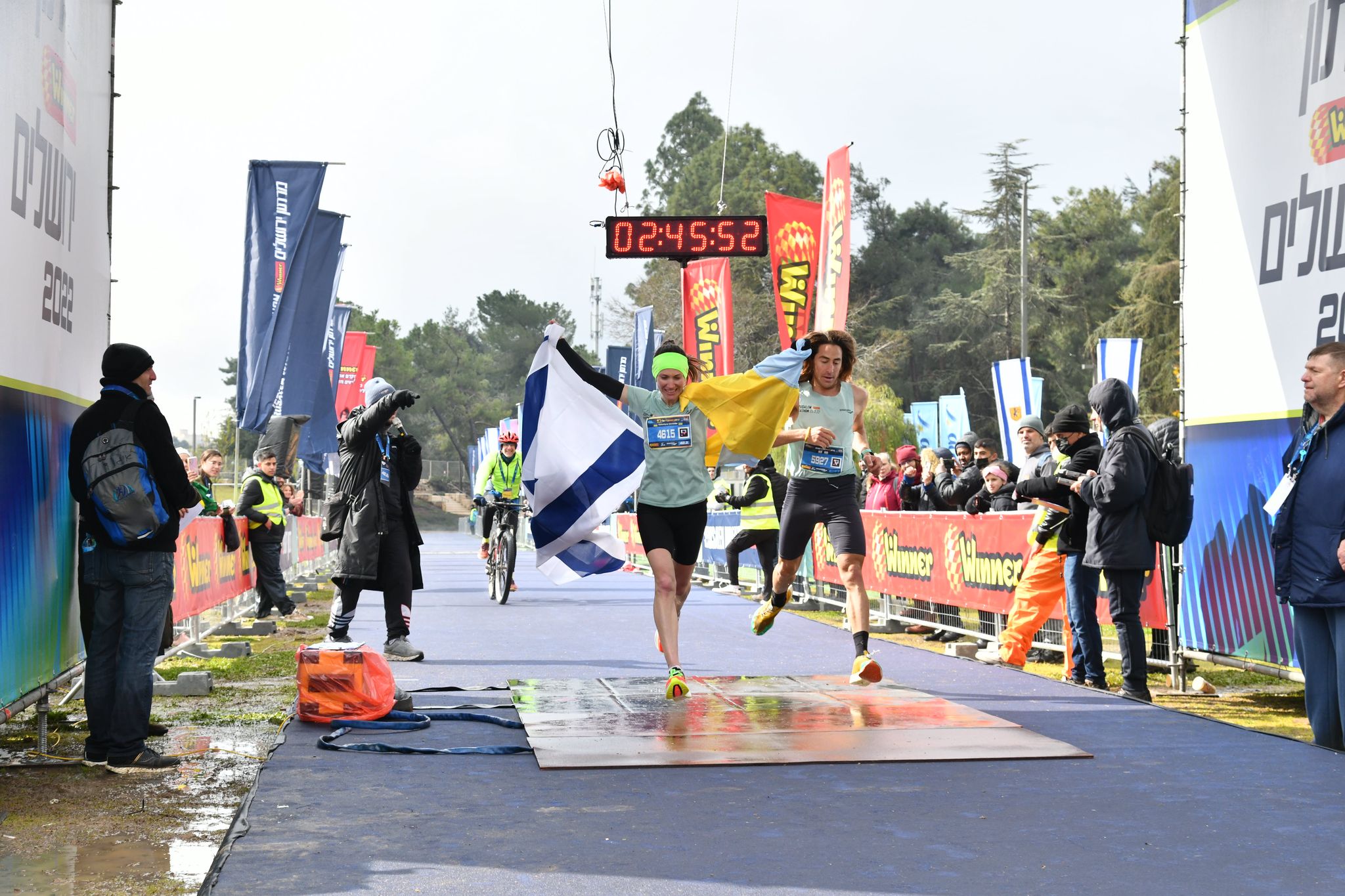 A runner crosses the finish line at the Jerusalem Marathon 2024