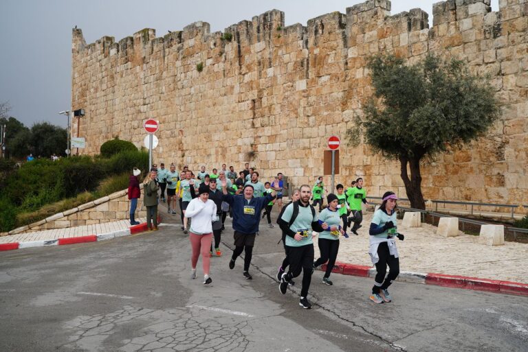 Runners passing through historic Jerusalem during the Jerusalem Marathon 2024