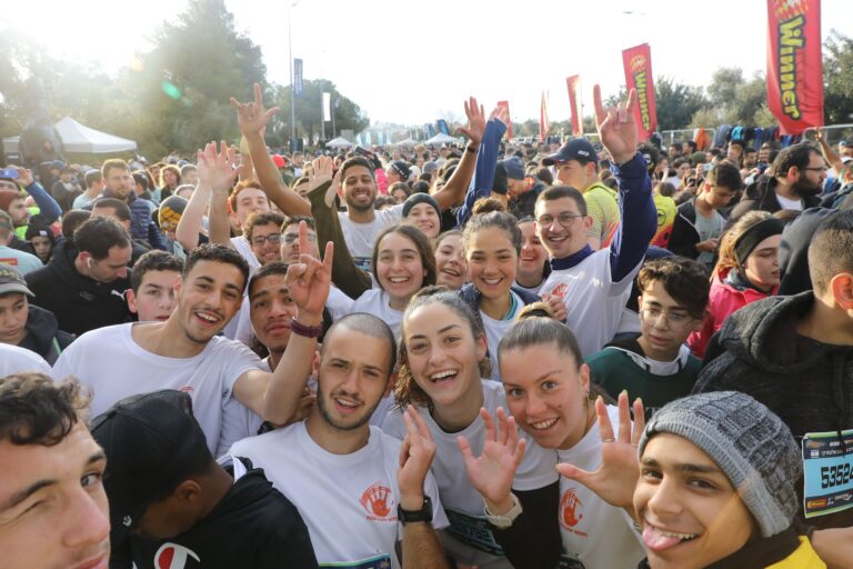 Photo of runners coming together ahead of the Jerusalem Marathon 2024