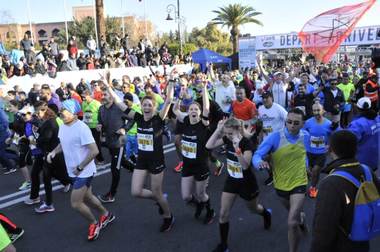 Runners cheering as they begin running in the Marrakech Marathon 2025