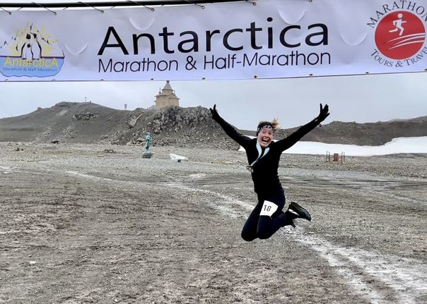 A runner celebrates having finished the Antarctica Marathon 2025