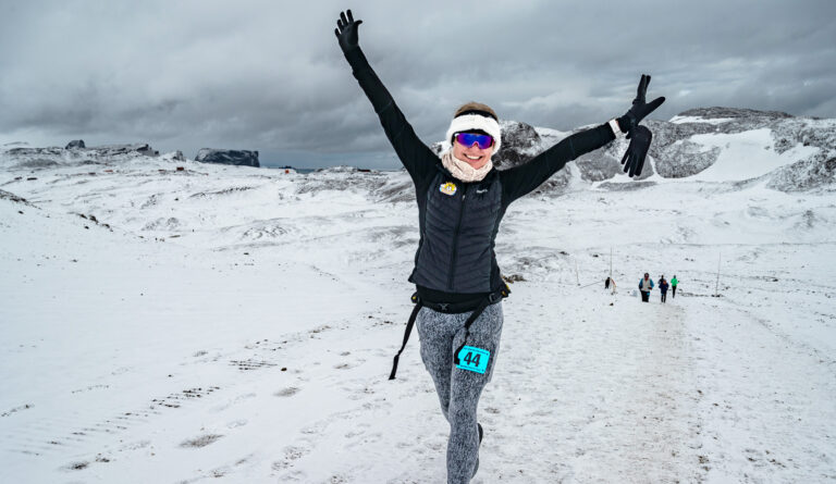 A runner poses whilst taking part in the Antarctica Marathon