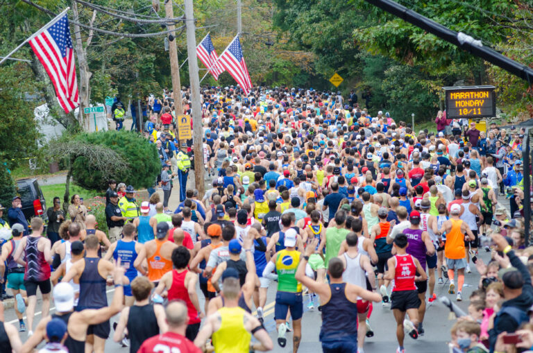 Photo of runners passing through the Boston streets during the Boston Marathon 2024