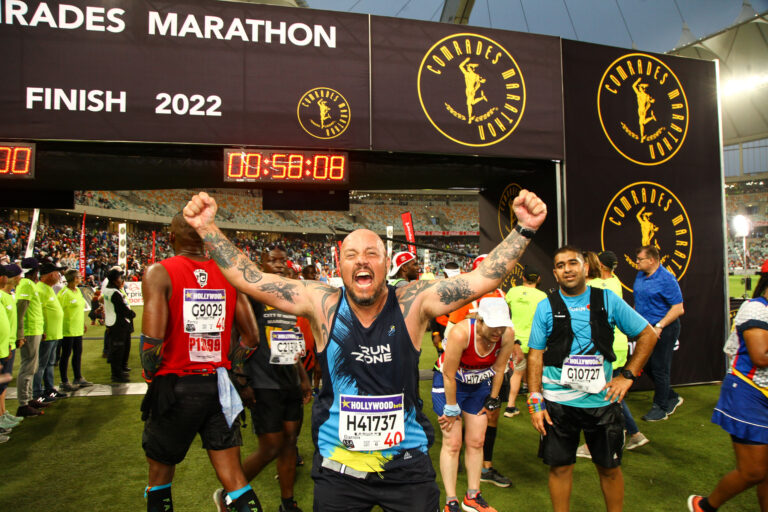Photo of runners celebrating having completed the Comrades Marathon 2024