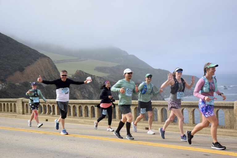 Photo of runners waving as they take part in the Big Sur Marathon 2024