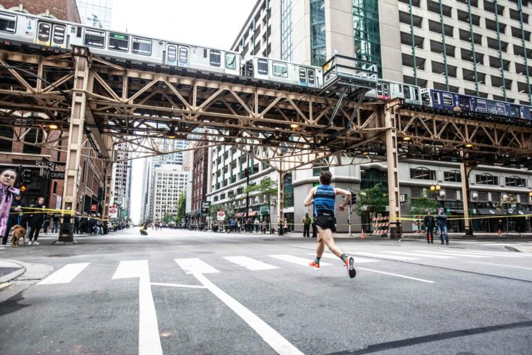 Picture of a Chicago Marathon runner passing beneath the Chicago metro system