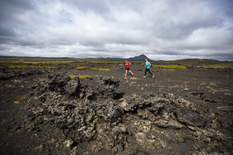 Runners crossing over beautiful terrain on the Iceland Volcano Marathon 2024