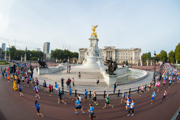 Runners passing the Victoria Memorial on the Royal Parks Half Marathon 2024 course