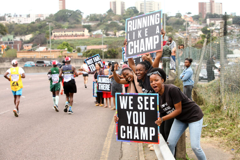 Photo of spectators encouraging runners at the Comrades Marathon 2024