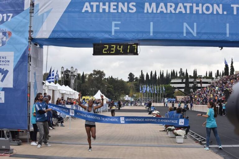 Photo of a runner crossing the finish line at the Athens Marathon 2024
