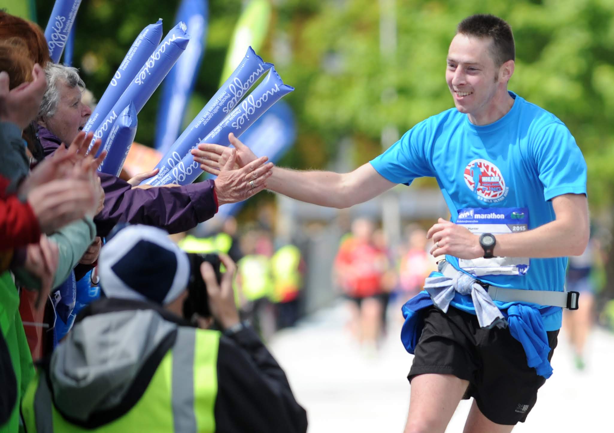 Photo of a runner interacting with crowds at the Edinburgh Marathon 2024