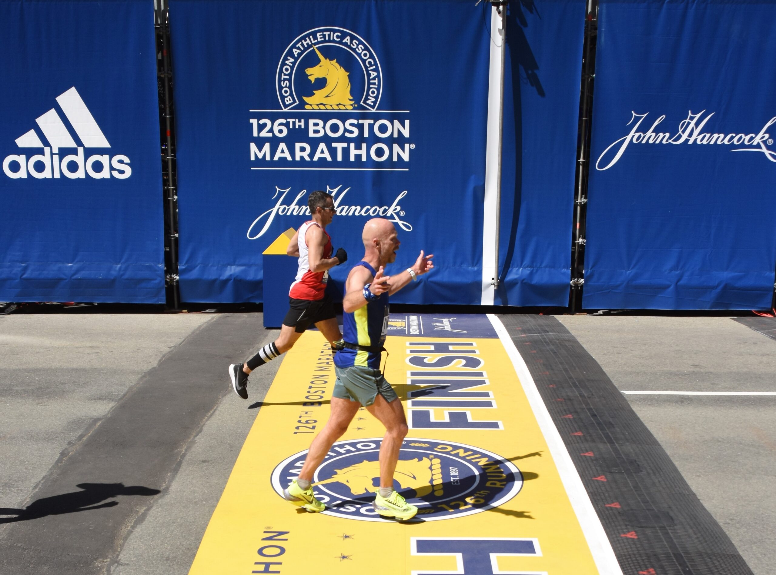 Photo of runners crossing the finish line at Boston Marathon 2024