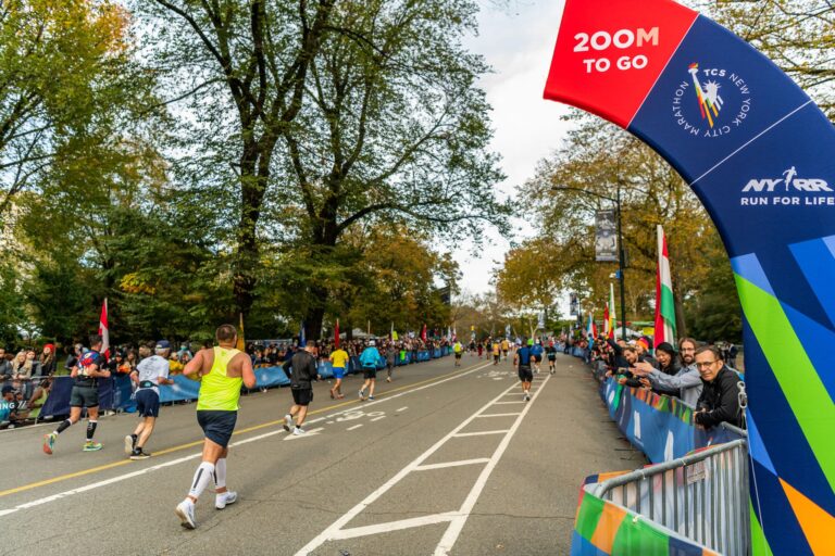 Runners passing the '200 metres to go' sign during the New York City Marathon 2024