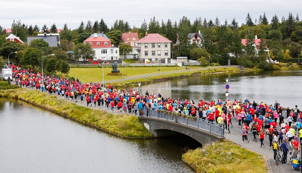 Runners crossing over a body of water on a route similar to the course which will be taken at the Reykjavik Marathon 2024