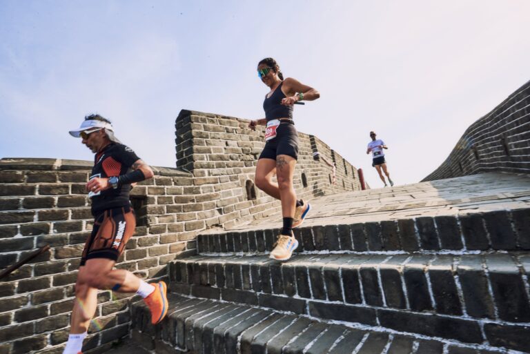 Runners descending steps on the Great Wall of China during the Great Wall Marathon 2025