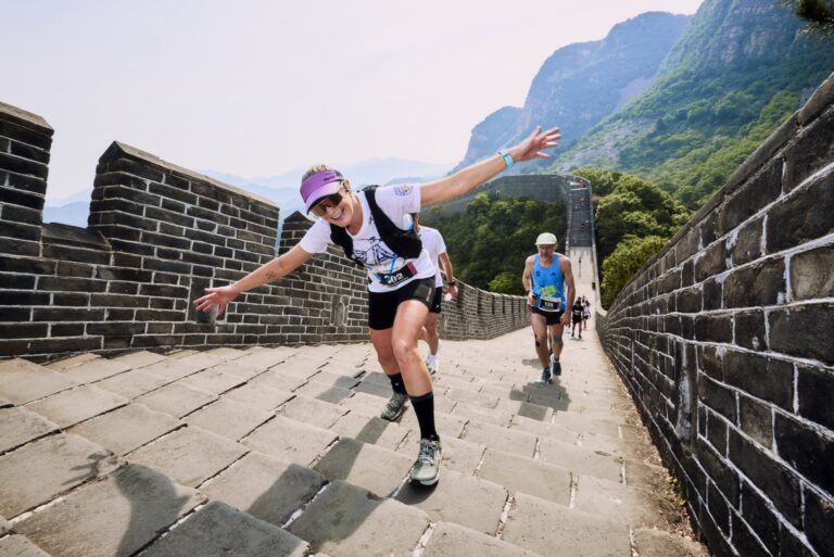 A runner poses to the camera during the Great Wall Marathon 2025