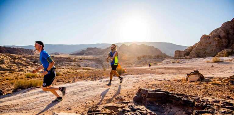 Runners passing along a desert path during the Petra Desert Marathon 2024