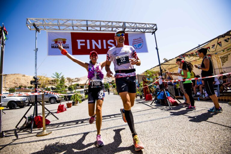 Runners crossing the finish line at the Petra Desert Marathon 2024