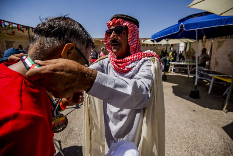 A runner is awarded a medal after completing the Petra Desert Marathon 2024