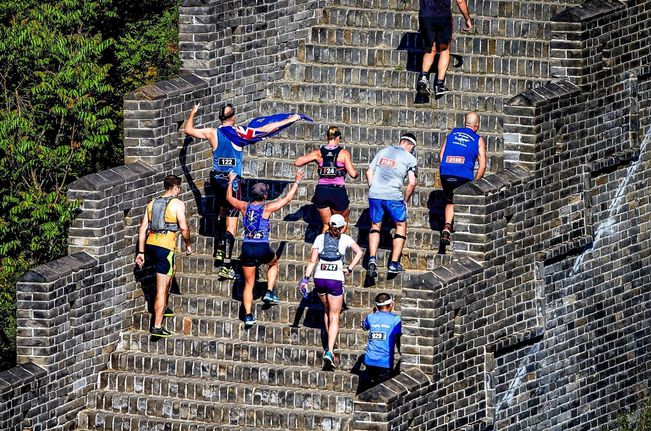 Photo of runners passing up stairs on the Great Wall Marathon 2024, which is one of the most challenging marathons in the world