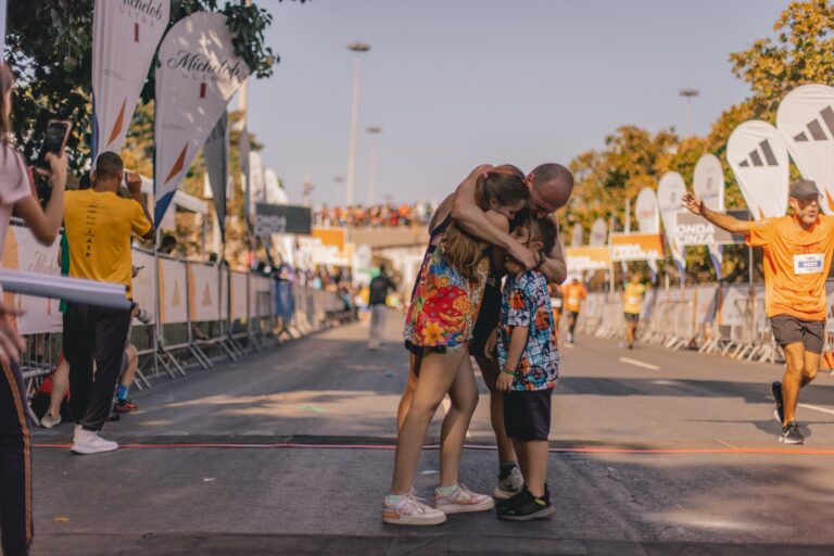 Photo of runners embracing at the conclusion of the Rio Marathon