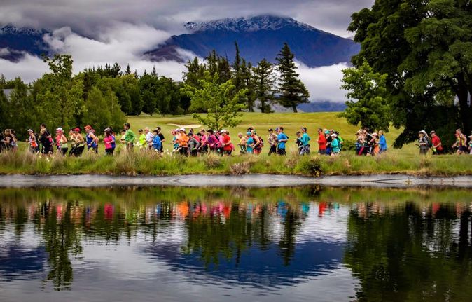 Runners passing a lake during the Queenstown Marathon 2024