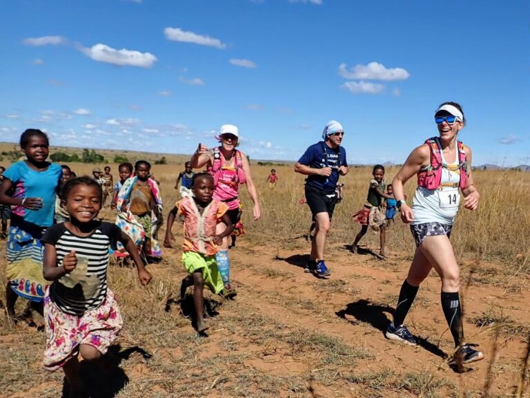 Runners running alongside locals at the Madgascar Marathon 2024