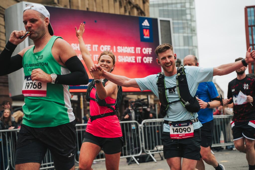 Couple running at Manchester Marathon