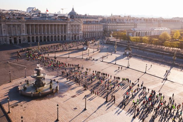 Runners pass a palace on the Paris Marathon