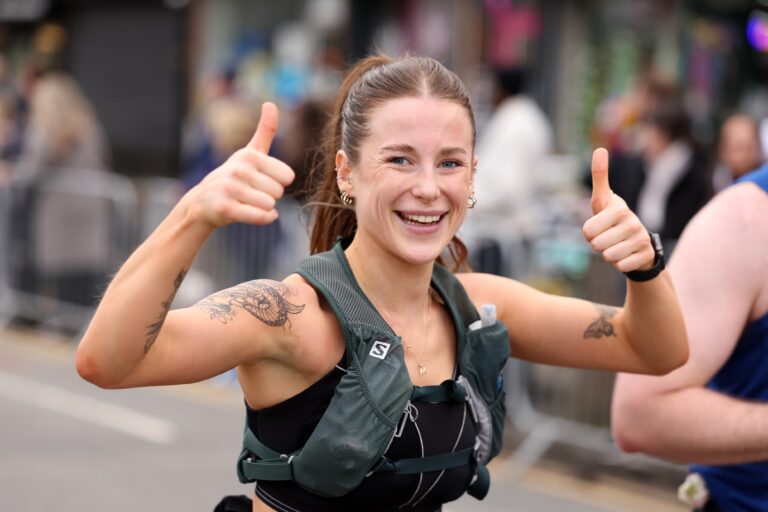 A runner gives a thumbs up to the camera during the Manchester Marathon 2025
