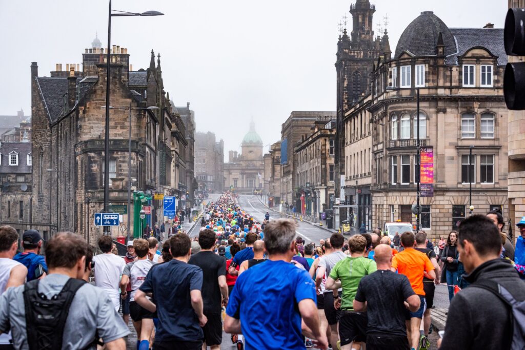 Runners passing through Edinburgh city centre during the Edinburgh Marathon festival