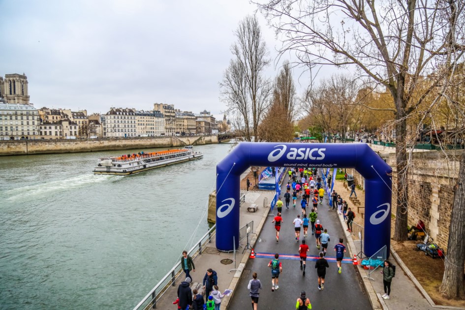 Runners passing alongside the River Seine in Paris during a half marathon or marathon event
