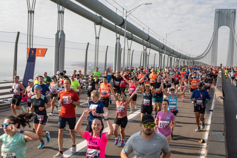 Runners crossing a bridge during the New York City Marathon 2025, attempting to set a Marathon New York Qualification Time