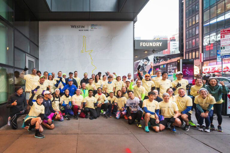 Runners pose outside the Westin Times Square, hotel for the New York City Marathon 2025 Abbott Age Group World Championships