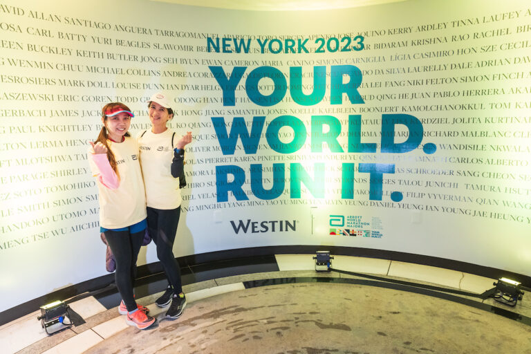 Two runners pose for the camera at the Westin Times Square, hotel for the New York City Marathon 2025 Abbott Age Group World Championships