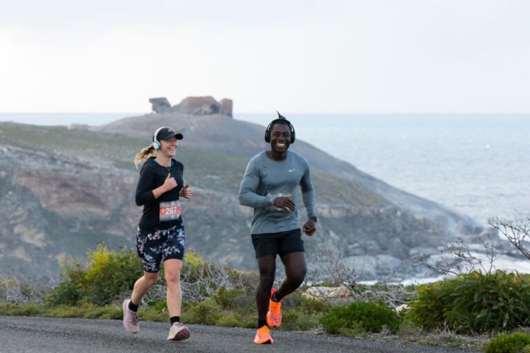 A male and female runner race together during the Kangaroo Island Marathon