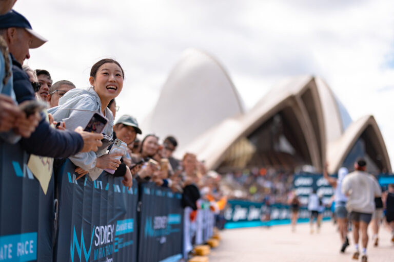 A spectator scans the crowd for a runner during the Sydney Australia Marathon