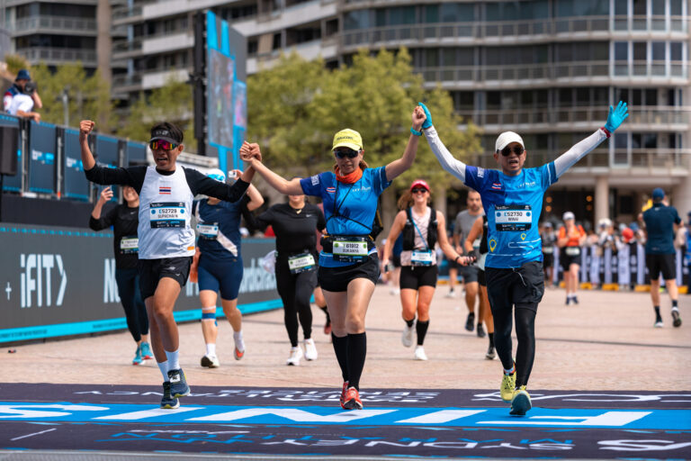 Runners cross the finish line together during the Sydney Australia Marathon