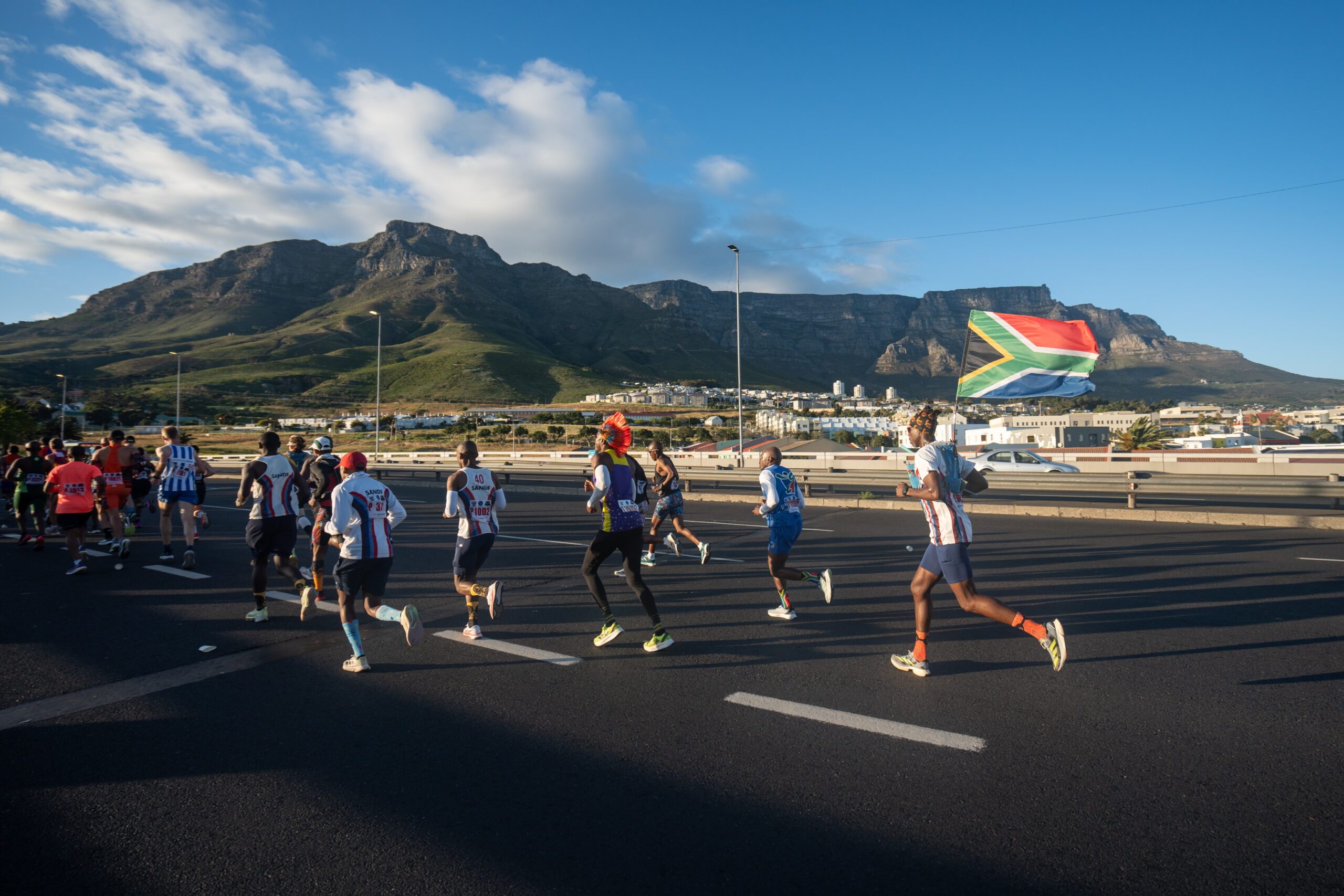 Runners passing beneath a mountain during the Cape Town Marathon 2026