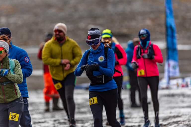 A woman checks her watch for her Antarctica Marathon results