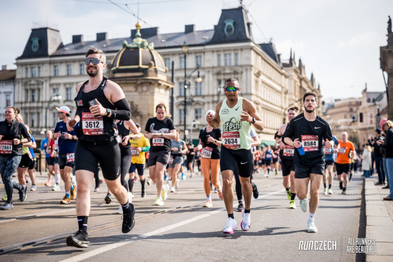Runners pass across a bridge during the Prague Half Marathon