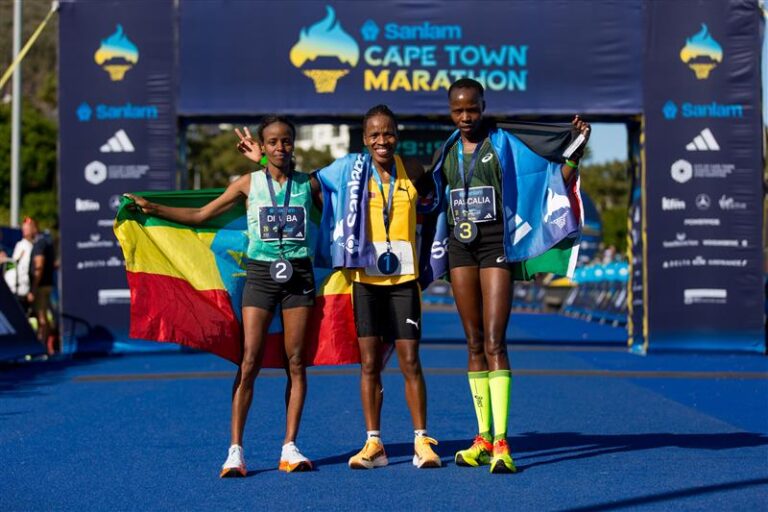 Elite runners pose at the finish line of the Cape Town Marathon