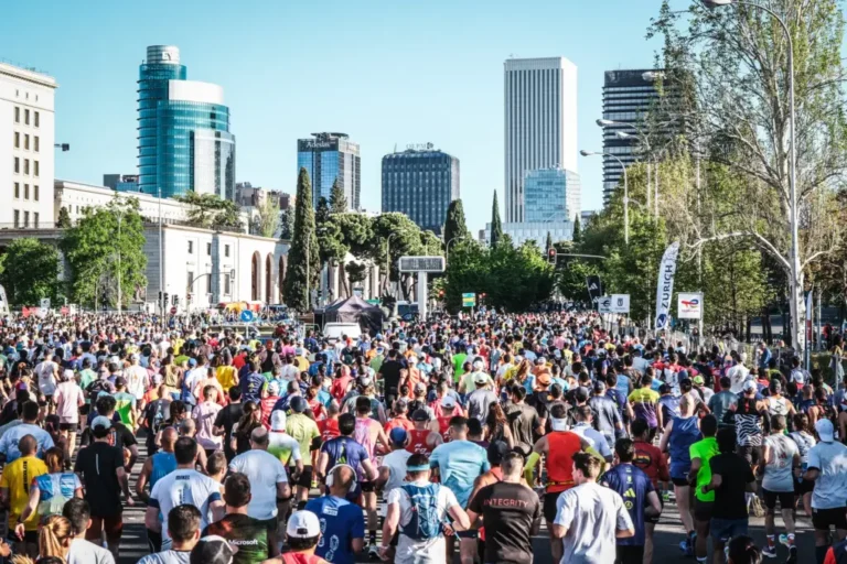 Runners passing below the city skyline at the Madrid Marathon 2027