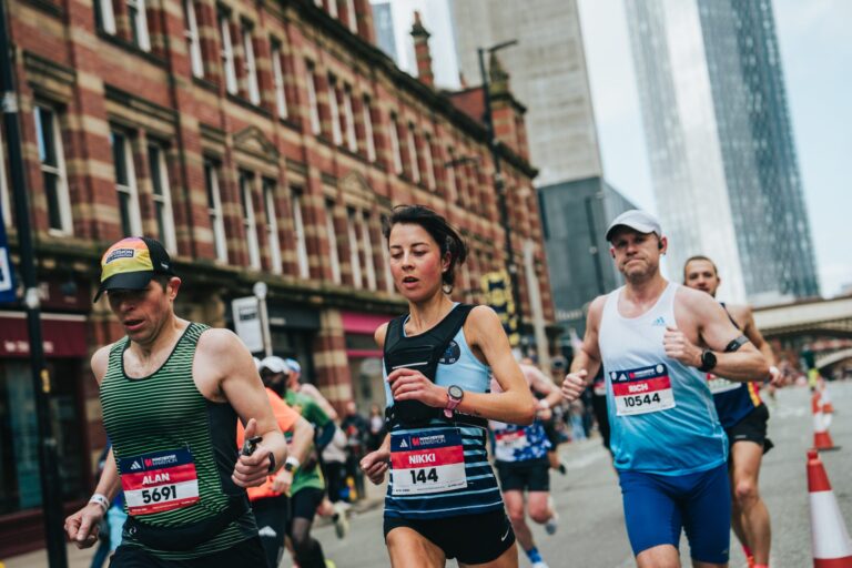 Runners pass along the famous Deansgate street during the Manchester Marathon 2026