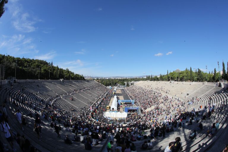 Runners cross the finish line in the Panathenaic Stadium, the historic finish line of the Athens Classic Marathon