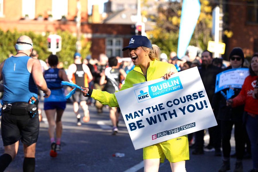 Photo of a woman encouraging runners from the roadside of the Dublin Marathon 2019, drawing parallels to National Quitters Day